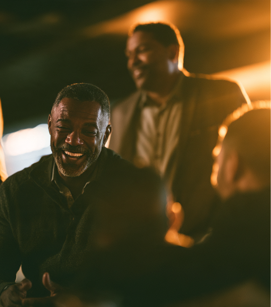 Men sharing a warm, relaxed conversation together